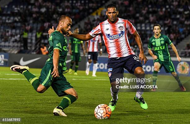 Colombia's Junior player Felix Noguera vies for the ball with Brazil's Chapecoense footballer Ananias during their Copa Sudamericana football match...