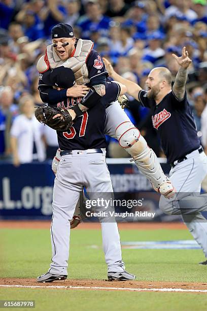 Cody Allen and Roberto Perez of the Cleveland Indians celebrate after defeating the Toronto Blue Jays with a score of 3 to 0 in game five to win the...
