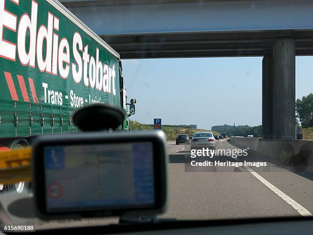 Passing Eddie Stobart truck on the A46 with satnav screen on windscreen. Artist