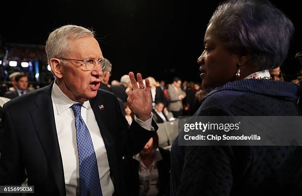 Senate Minority Leader Sen. Harry Reid speaks with DNC Chair Donna Brazile before the start of the third U.S. Presidential debate at the Thomas &...