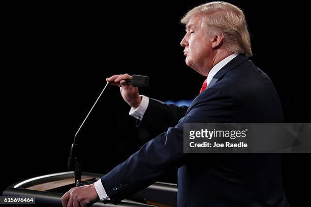 Republican presidential nominee Donald Trump adjusts the microphone during the third U.S. Presidential debate at the Thomas & Mack Center on October...