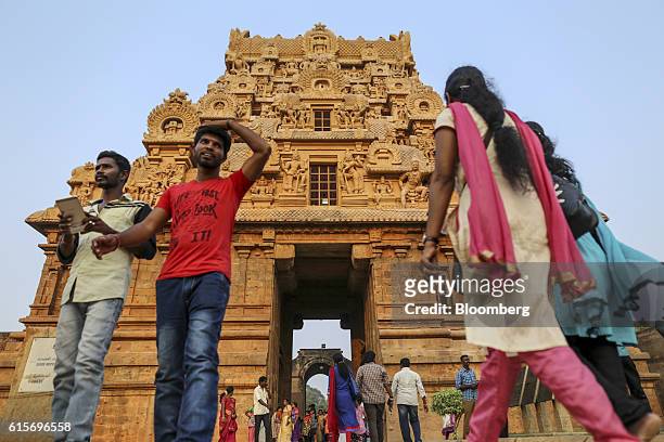 Devotees and other visitors walk near an entrance to the Brihadeshwara Temple in Thanjavur, Tamil Nadu, India, on Sunday, Oct. 16, 2016. India's new...
