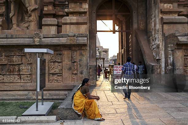 Devotees sits at an entrance to the Brihadeshwara Temple in Thanjavur, Tamil Nadu, India, on Sunday, Oct. 16, 2016. India's new central bank head...