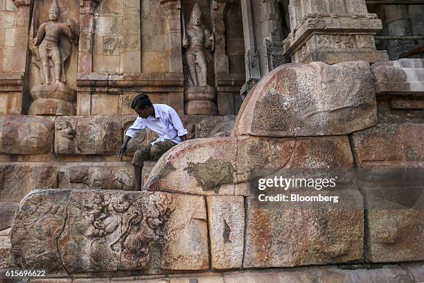 Devotee sits outside the Brihadeshwara Temple in Thanjavur, Tamil Nadu, India, on Sunday, Oct. 16, 2016. India's new central bank head seems to be...