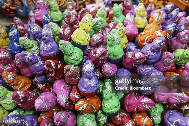 Religious figurines are displayed for sale at the Brihadeshwara Temple in Thanjavur, Tamil Nadu, India, on Sunday, Oct. 16, 2016. India's new central...