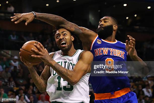 Kyle O'Quinn of the New York Knicks defends James Young of the Boston Celtics during the third quarter at TD Garden on October 17, 2016 in Boston,...