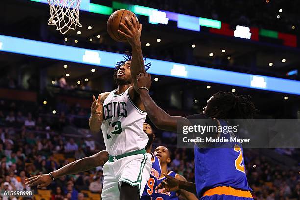 James Young of the Boston Celtics takes a shot against Maurice Daly Ndour of the New York Knicks during the third quarter at TD Garden on October 17,...