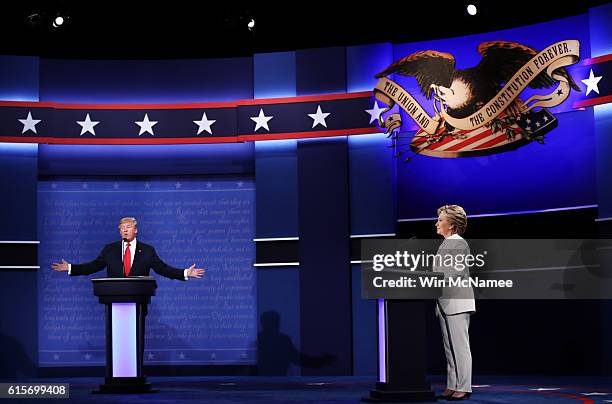 Republican presidential nominee Donald Trump speaks as Democratic presidential nominee former Secretary of State Hillary Clinton looks on during the...