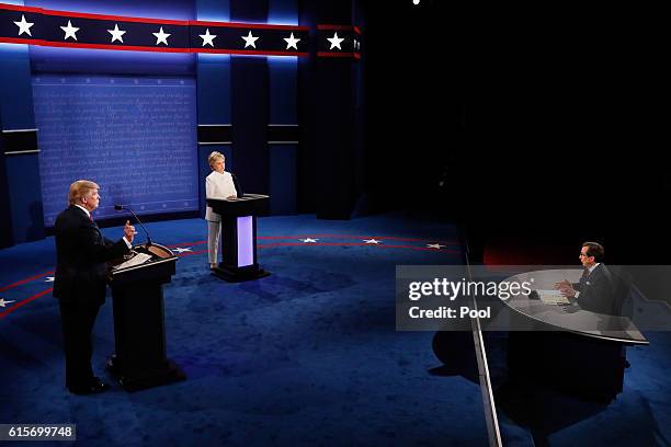 Republican presidential nominee Donald Trump and Democratic presidential nominee former Secretary of State Hillary Clinton listen to Fox News anchors...