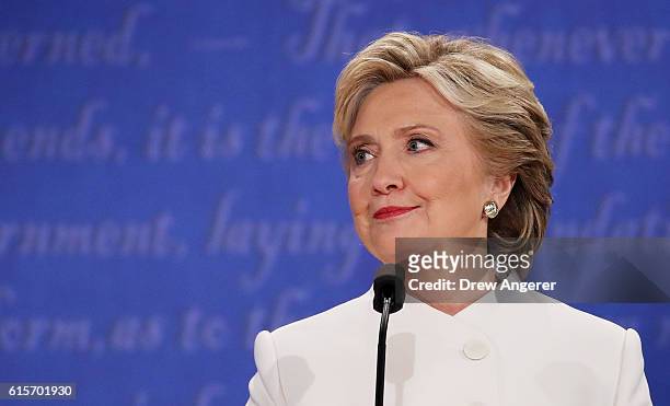 Democratic presidential nominee former Secretary of State Hillary Clinton listens to Republican presidential nominee Donald Trump speak during the...