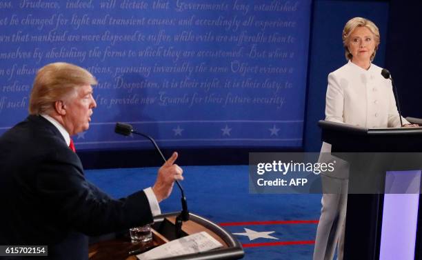 Democratic nominee Hillary Clinton looks on as Republican nominee Donald Trump speaks during the final presidential debate at the Thomas & Mack...