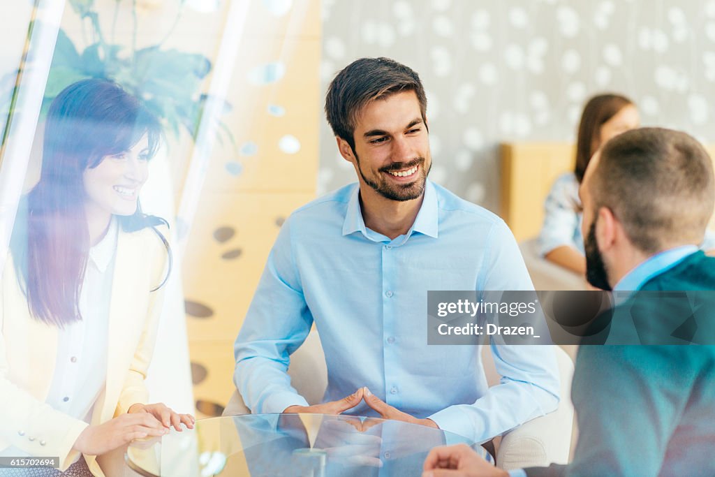 Discussion between friend in hotel lobby