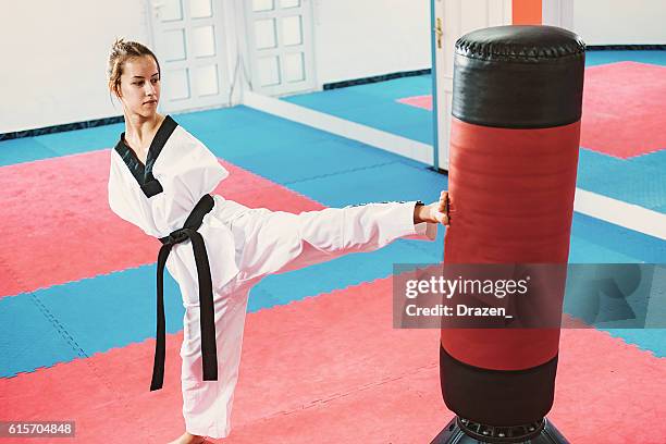 Armless young woman practicing taekwondo