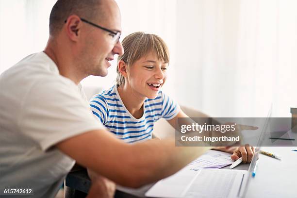 father doing homework with his daughter - dad homework stock pictures, royalty-free photos & images