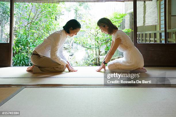 two japanese women bowing with respect - social grace stock pictures, royalty-free photos & images