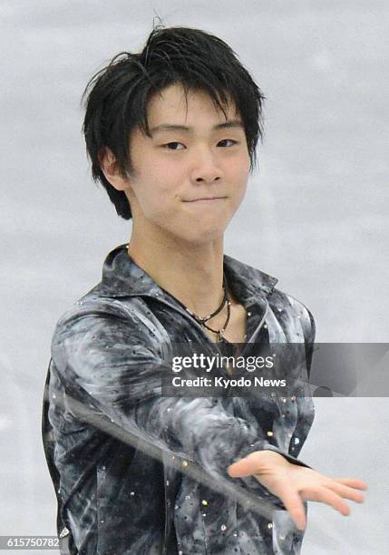 Japan - Japan's Yuzuru Hanyu acknowledges cheers from spectators after performing in the men's short program of the NHK Trophy at Sekisui Heim Super...