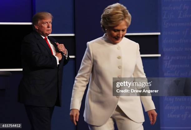 Democratic presidential nominee former Secretary of State Hillary Clinton walks off stage as Republican presidential nominee Donald Trump looks on...