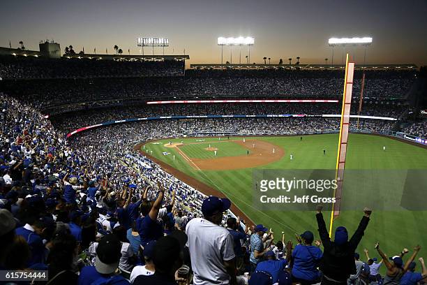 Chicago Cubs fans cheer after Addison Russell of the Chicago Cubs hits a two-run home run in the fourth inning against the Los Angeles Dodgers in...