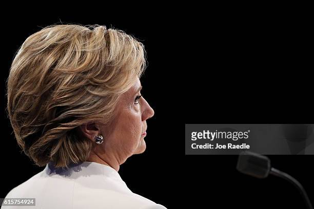 Democratic presidential nominee former Secretary of State Hillary Clinton listens to Republican presidential nominee Donald Trump speak during the...