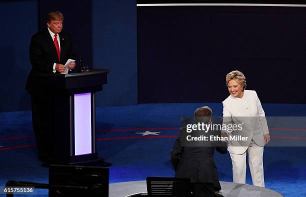 Democratic presidential nominee former Secretary of State Hillary Clinton shakes hands with Fox News anchor and moderator Chris Wallace as Republican...