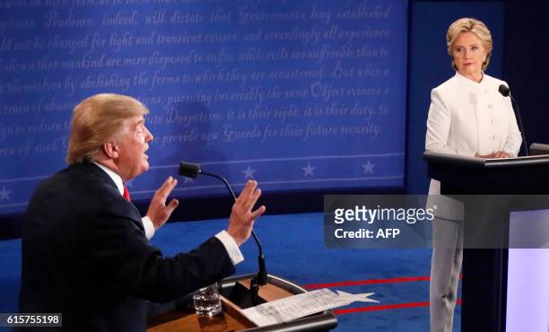 Republican nominee Donald Trump gestures as Democratic nominee Hillary Clinton looks on during the final presidential debate at the Thomas & Mack...