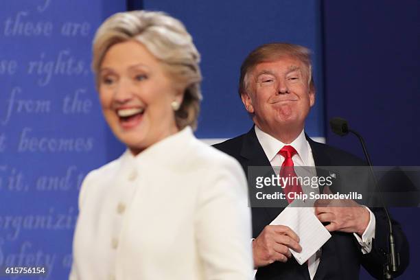 Democratic presidential nominee former Secretary of State Hillary Clinton walks off stage as Republican presidential nominee Donald Trump smiles...