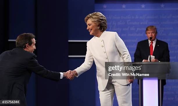 Democratic presidential nominee former Secretary of State Hillary Clinton shakes hands with Fox News anchor and moderator Chris Wallace as Republican...