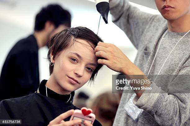 Model gets ready backstage ahead of the Anne-Sofie Madsen show as part of Amazon Fashion Week TOKYO 2017 S/S at Shibuya Hikarie on October 20, 2016...