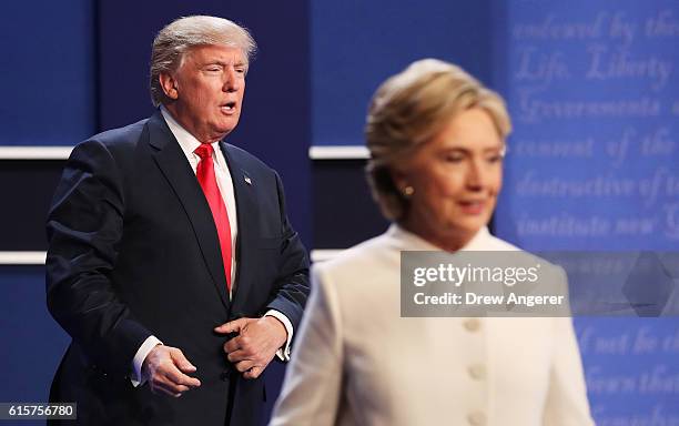 Democratic presidential nominee former Secretary of State Hillary Clinton walks off stage as Republican presidential nominee Donald Trump looks on...