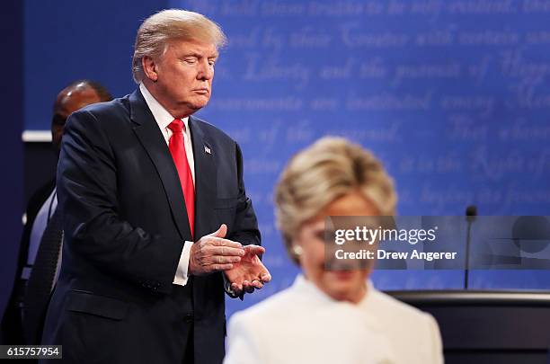 Democratic presidential nominee former Secretary of State Hillary Clinton walks off stage as Republican presidential nominee Donald Trump looks on...