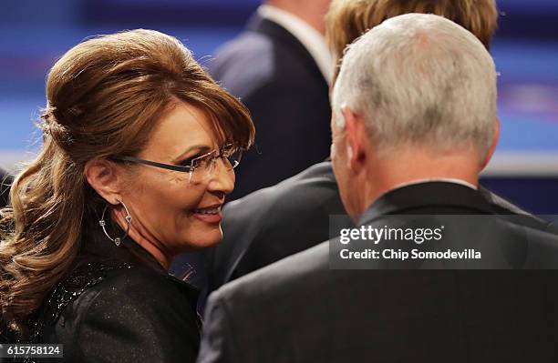 Former Gov. Sarah Palin speaks with Republican vice presidential nominee Mike Pence after the third U.S. Presidential debate at the Thomas & Mack...