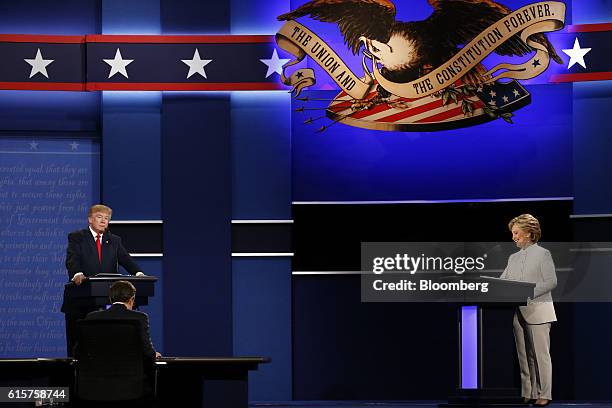 Hillary Clinton, 2016 Democratic presidential nominee, smiles as Donald Trump, 2016 Republican presidential nominee, stands during the third U.S....