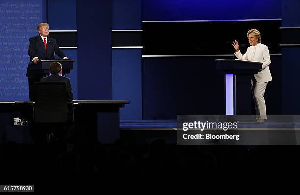 Hillary Clinton, 2016 Democratic presidential nominee, speaks as Donald Trump, 2016 Republican presidential nominee, listens during the third U.S....