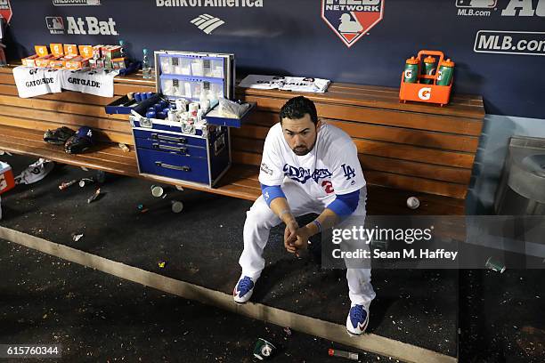 Adrian Gonzalez of the Los Angeles Dodgers looks on from the dugout against the Chicago Cubs in game four of the National League Championship Series...