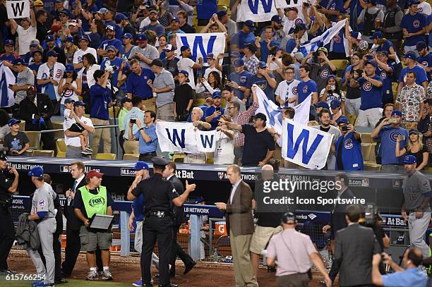 The Cubs fans hold up their "W" banners to celebrate the victory during game four of the National League Championship Series between the Chicago Cubs...