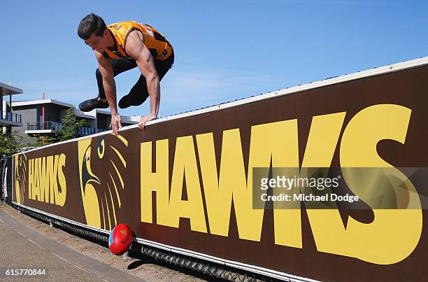 New recruit Jaeger O'Meara ops over the fence after posing during a Hawthorn Hawks AFL media opportunity at Waverley Park on October 20, 2016 in...