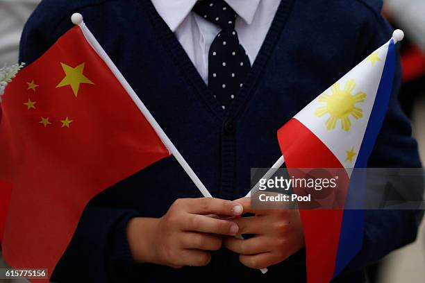 Children hold national flags of China and the Philippines before President of the Philippines Rodrigo Duterte and China's President Xi Jinping attend...