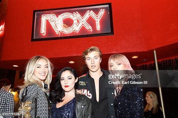 Daisy Smith, Starlie Smith, Lucky Blue Smith and Pyper America Smith members of The Atomics pose for a photo before their performance at The Roxy...
