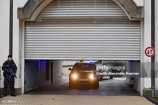 Police cars with members of Germany's elite police unit, the Spezialeinsatzkommando , leave the Oberlandesgericht Celle courthouse during the first...