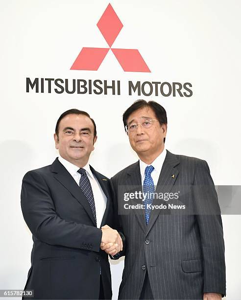 Nissan Motor Co. Chief Executive Officer Carlos Ghosn and Mitsubishi Motors Corp. Chairman and President Osamu Masuko attend a press conference in...