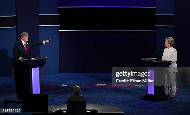 Republican presidential nominee Donald Trump speaks as Democratic presidential nominee former Secretary of State Hillary Clinton looks on during the...