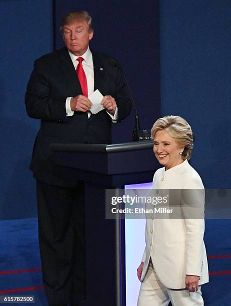 Democratic presidential nominee former Secretary of State Hillary Clinton walks off stage as Republican presidential nominee Donald Trump looks on at...