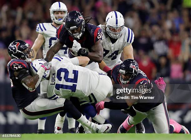 Andrew Luck of the Indianapolis Colts is sacked by Benardrick McKinney of the Houston Texans along with Jadeveon Clowney and Christian Covington in...
