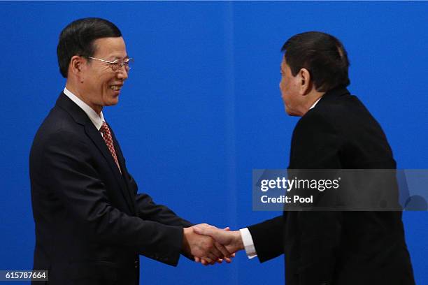 Chinese Vice-Premier Zhang Gaoli shakes hands with Philippines President Rodrigo Duterte after he made a speech during the Philippines - China Trade...
