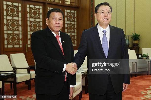 Philippines President Rodrigo Duterte shakes hands with Zhang Dejiang, Chairman of the Standing Committee of the National People's Congress of China...