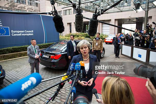 British Prime Minister Theresa May addresses assembled media as she arrives at the Council of the European Union on the first day of a two day summit...