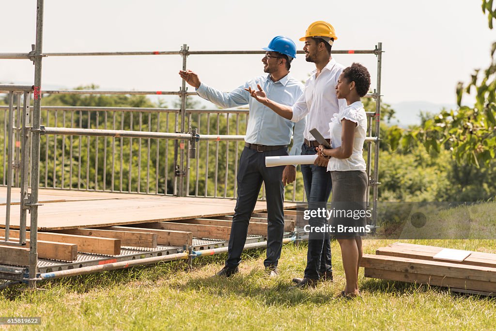 Group of happy architects planning their project together.