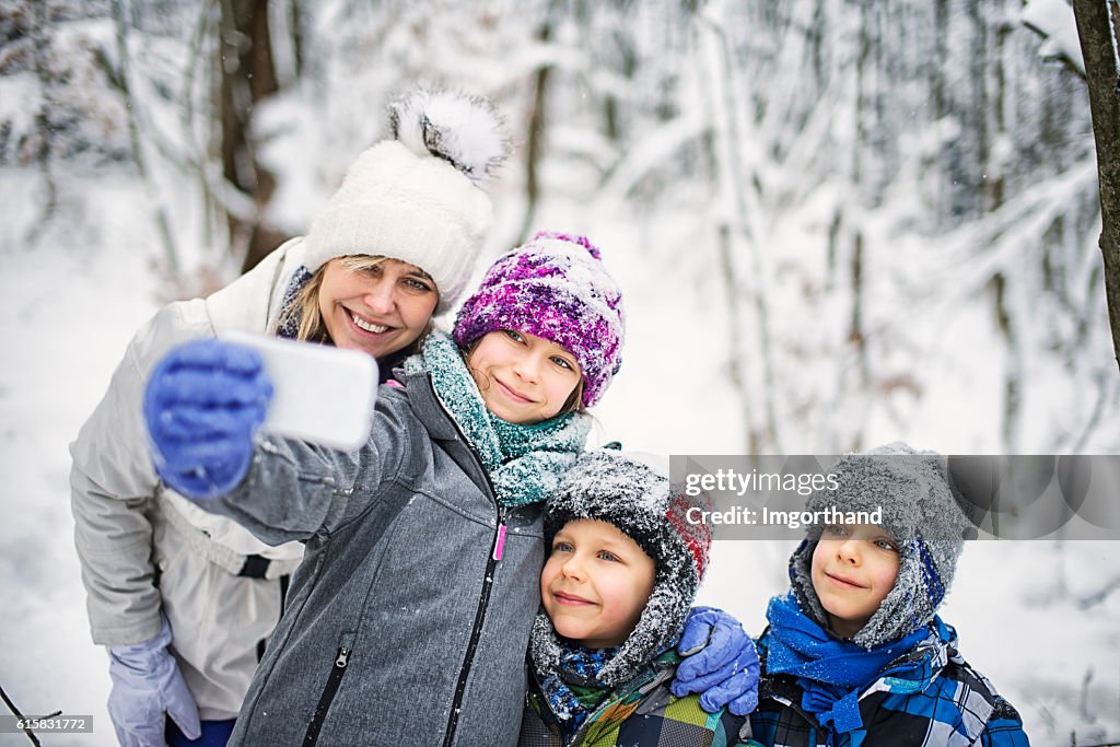 Family enjoying winter walk in forest.