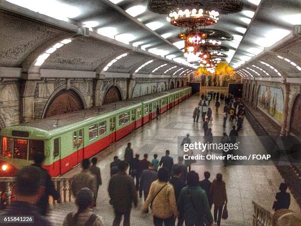 commuters at a pyongyang subway station, north korea - pyongyang station stock pictures, royalty-free photos & images