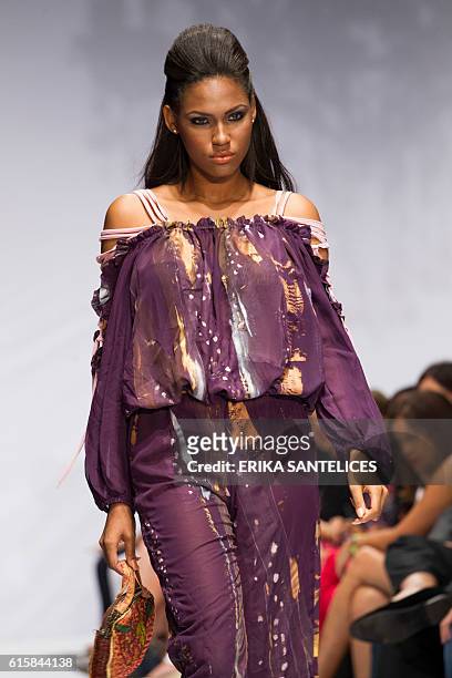 Model displays a creation by Haitian Michel Chataigne during the Dominicana Moda Fashion Week in Santo Domingo on October 19, 2016. / AFP / afp /...
